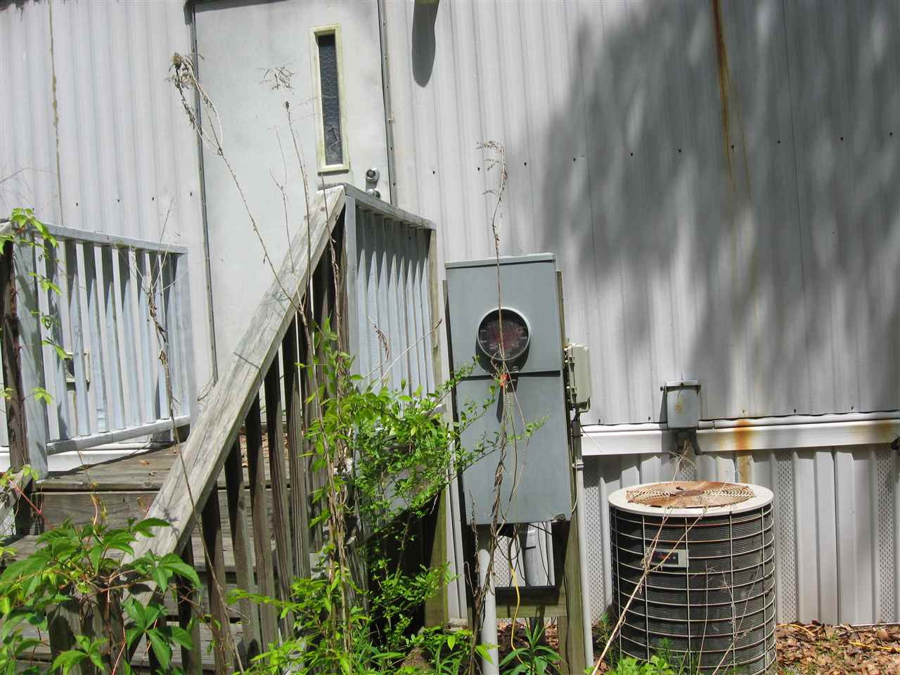 925 C Micro Road West Micro, NC 27555 - Photo 9 of 12 HVAC unit is old and Electrical power has been shut off for several years. Exterior Back