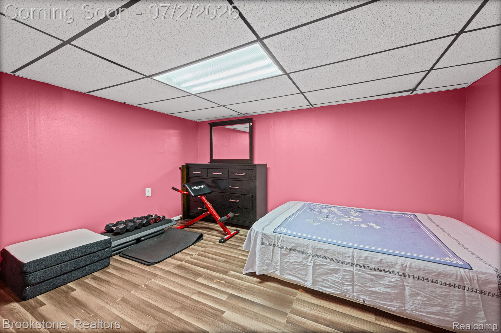 1925 Nicholas Court Warren, MI 48092 - Photo 21 of 26 Room featuring wood-finish flooring, a drop ceiling with recessed lighting, and vibrant pink walls