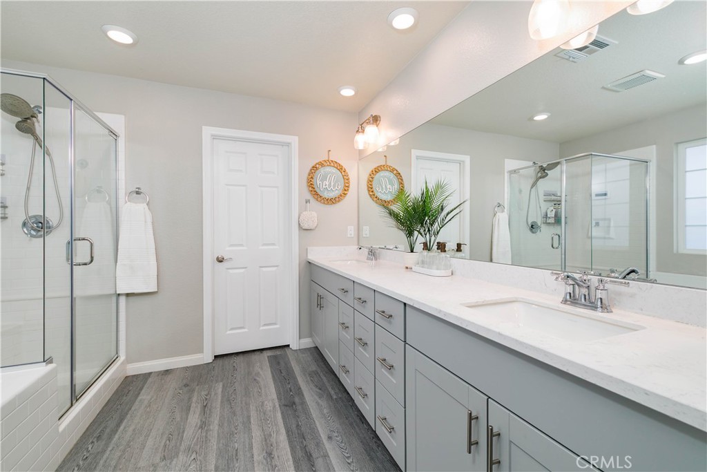 3682 Loheria Street Riverside, CA 92503 - Photo 18 of 37 a bathroom with a double vanity sink and a mirror with shower