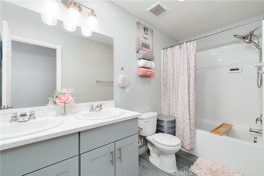 3682 Loheria Street Riverside, CA 92503 - Photo 25 of 37 a bathroom with a sink toilet vanity and shower