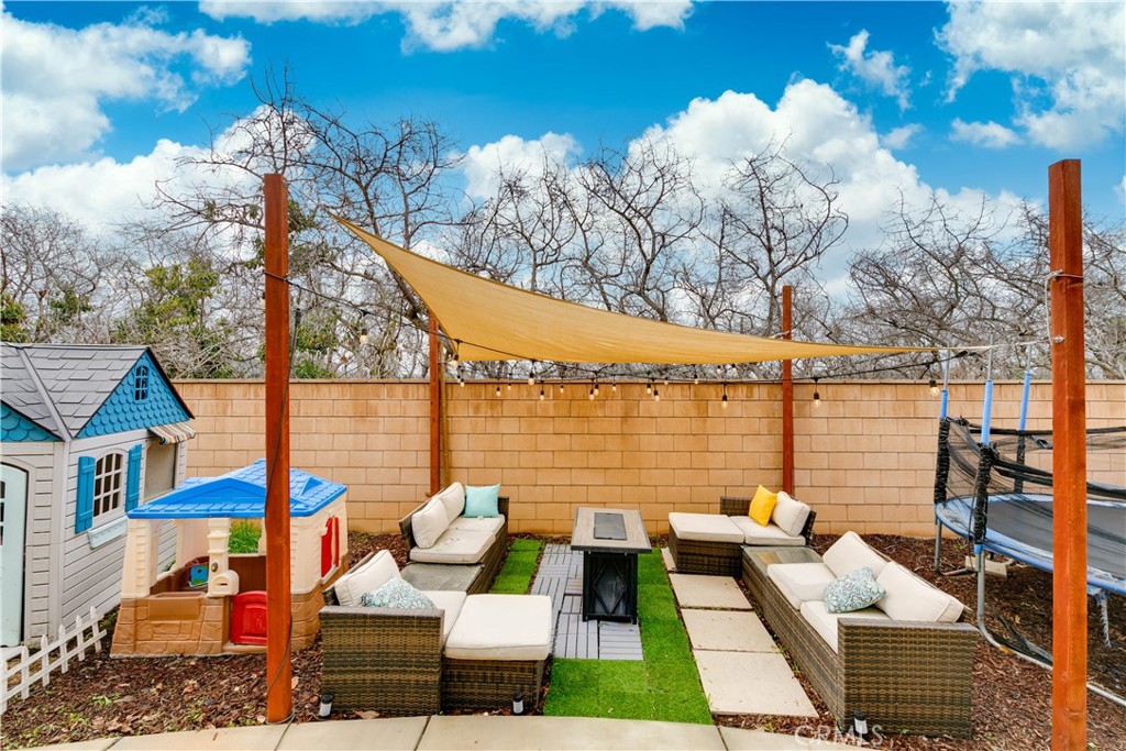 3682 Loheria Street Riverside, CA 92503 - Photo 33 of 37 a view of a patio with couches table and chairs with wooden floor