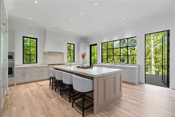 a kitchen with sink a window and cabinets