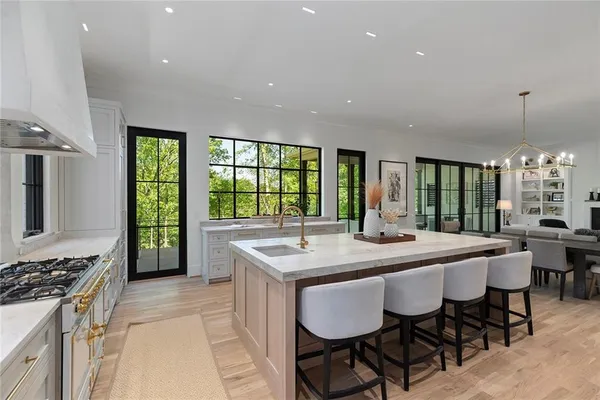 a kitchen with stainless steel appliances granite countertop a sink and a white cabinets