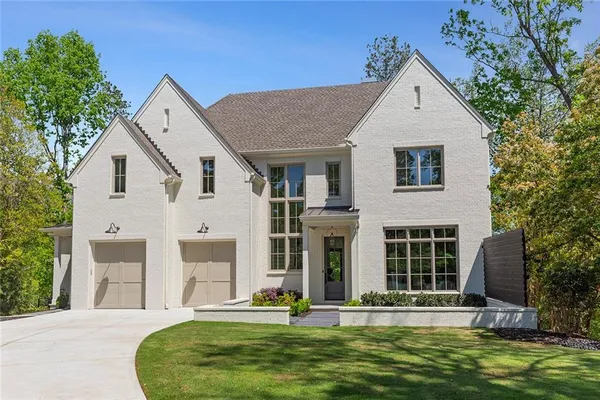 a view of a house with swimming pool next to a yard