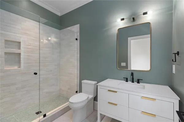 a bathroom with a sink a toilet and shower