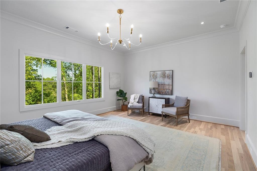 3290 Dunlop Court Atlanta, GA 30319 - Photo 42 of 81 a bedroom with a bed and a chandelier
