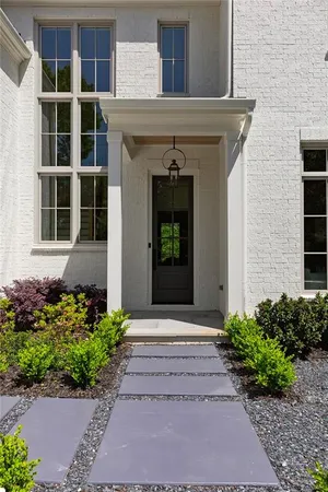 a view of a hallway with wooden floor and entryway