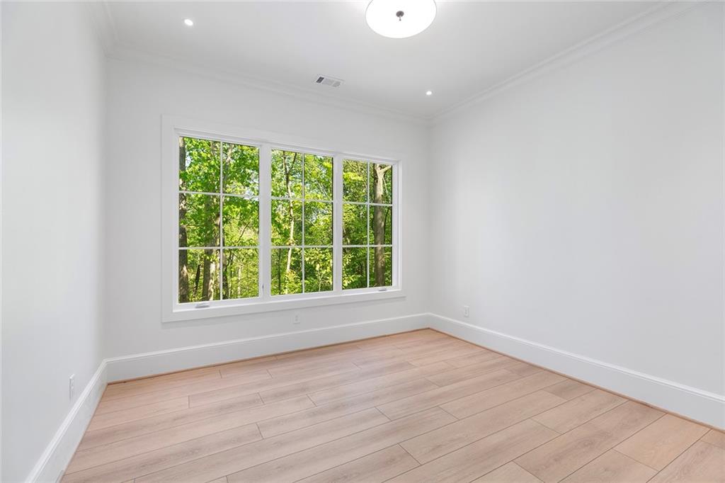 3290 Dunlop Court Atlanta, GA 30319 - Photo 53 of 81 an empty room with wooden floor and windows