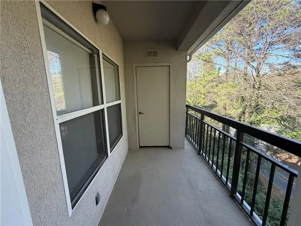 a view of a livingroom with wooden floor a fireplace and window
