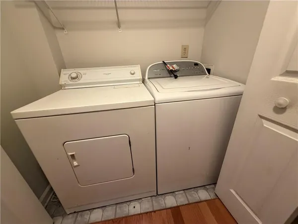 a view of a hallway with wooden floor and flat screen tv