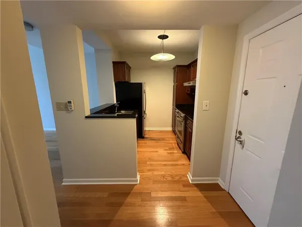 a bathroom with a granite countertop bathtub shower and toilet