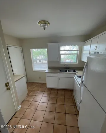a kitchen with stainless steel appliances a refrigerator sink and microwave