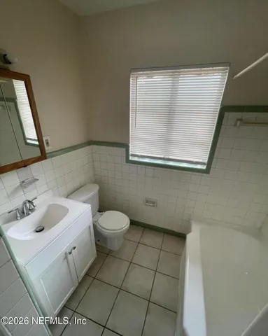 a bathroom with a sink toilet and mirror