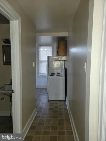 a kitchen with a refrigerator and a stove