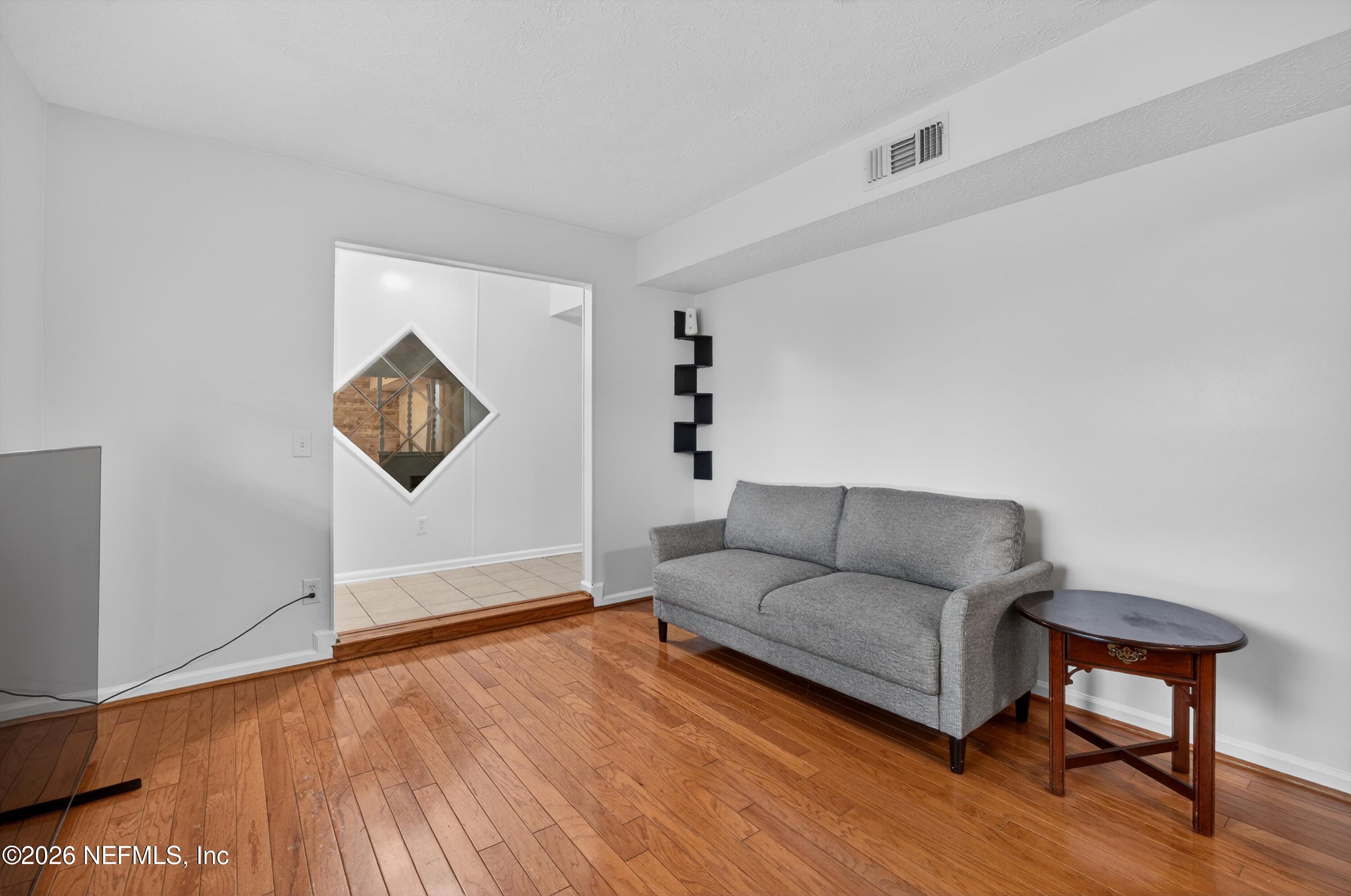 3570 Grassy Ride Drive Jacksonville, FL 32223 - Photo 11 of 51 a living room with furniture and a wooden floor