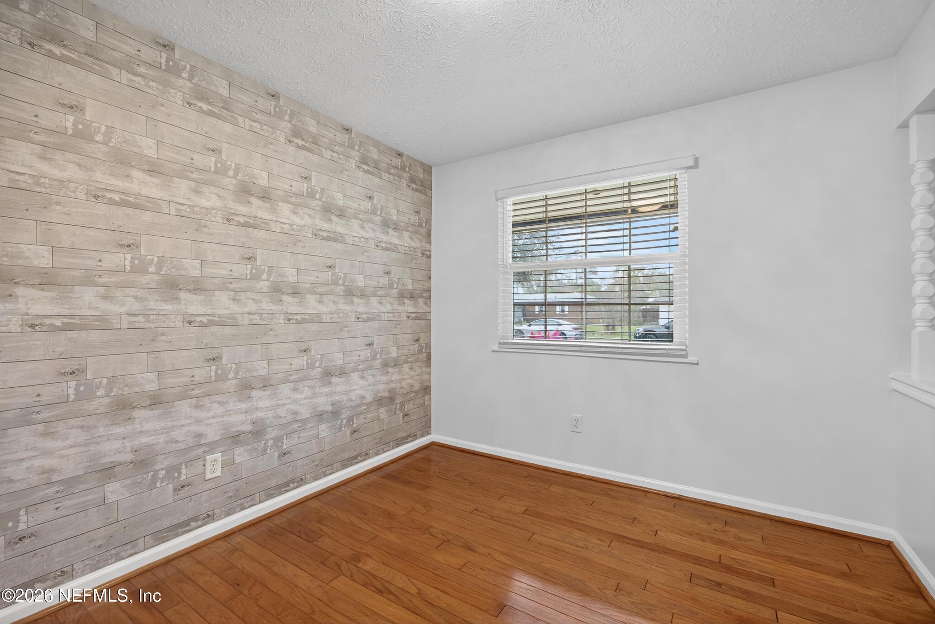 3570 Grassy Ride Drive Jacksonville, FL 32223 - Photo 12 of 51 a view of empty room with wooden floor and fan
