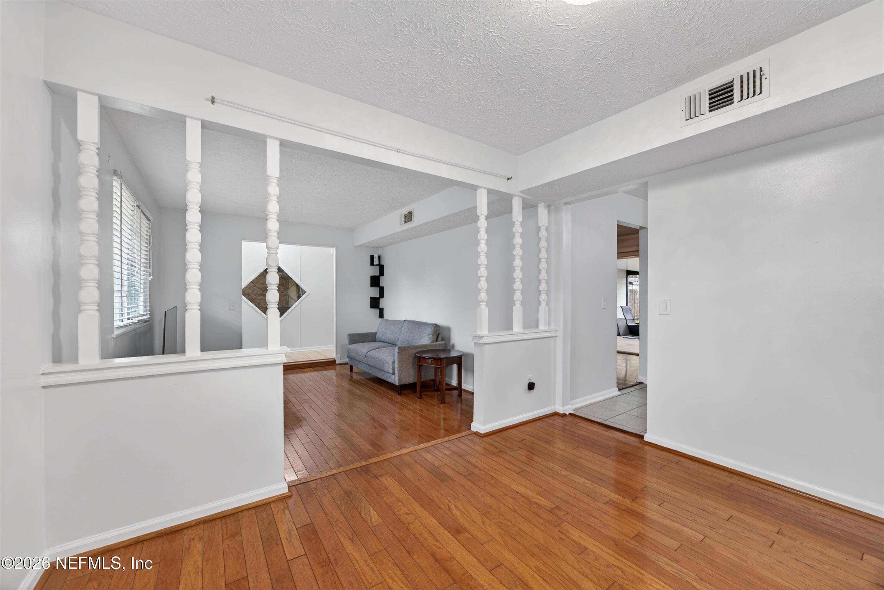 3570 Grassy Ride Drive Jacksonville, FL 32223 - Photo 13 of 51 a view of empty room with wooden floor and window
