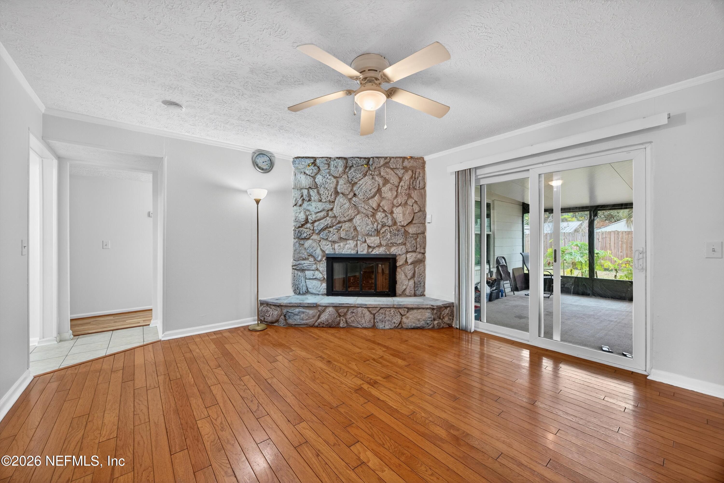 3570 Grassy Ride Drive Jacksonville, FL 32223 - Photo 14 of 51 a view of an empty room with a fireplace and a window