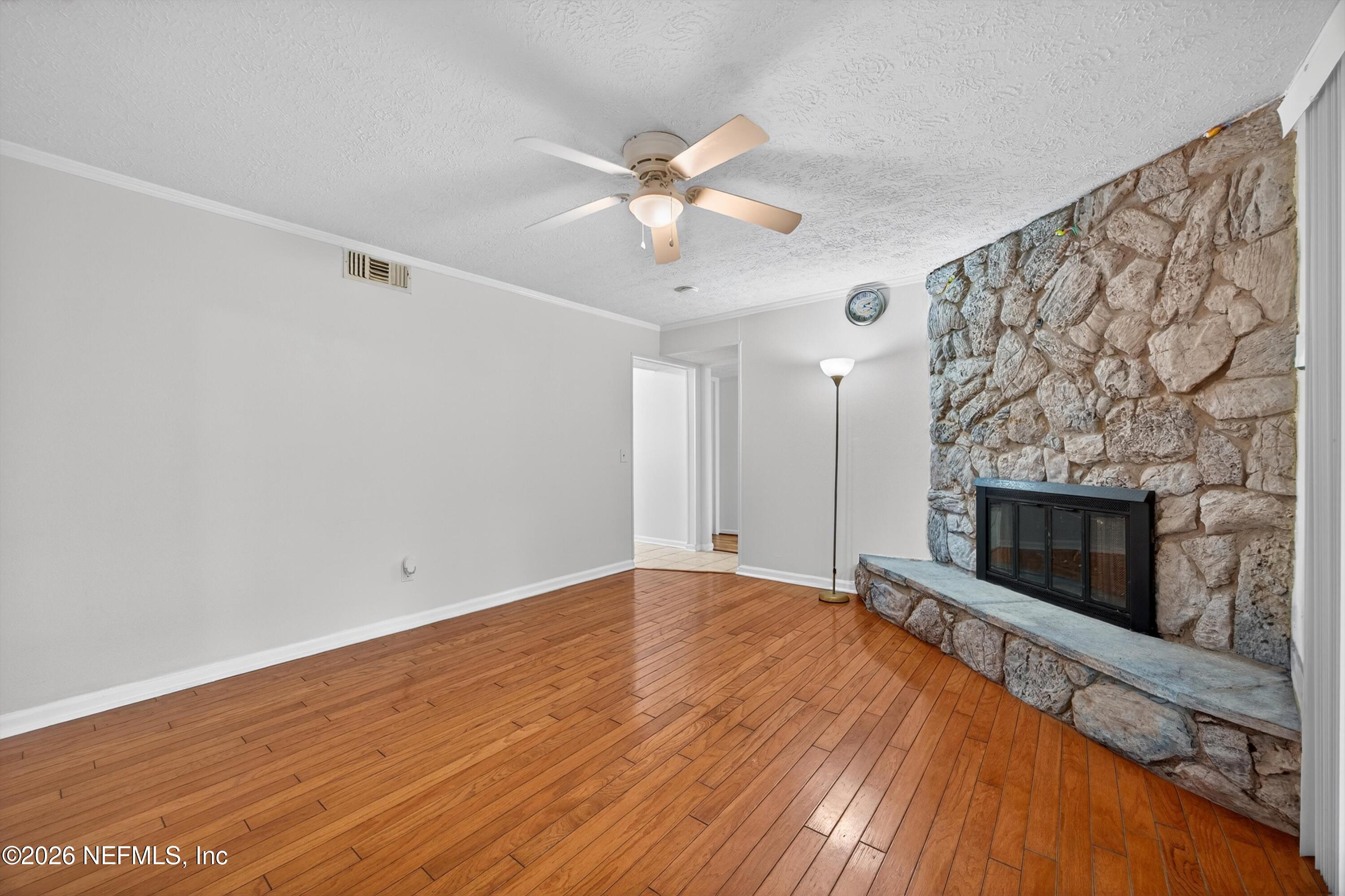 3570 Grassy Ride Drive Jacksonville, FL 32223 - Photo 15 of 51 wooden floor in an empty room with a fireplace