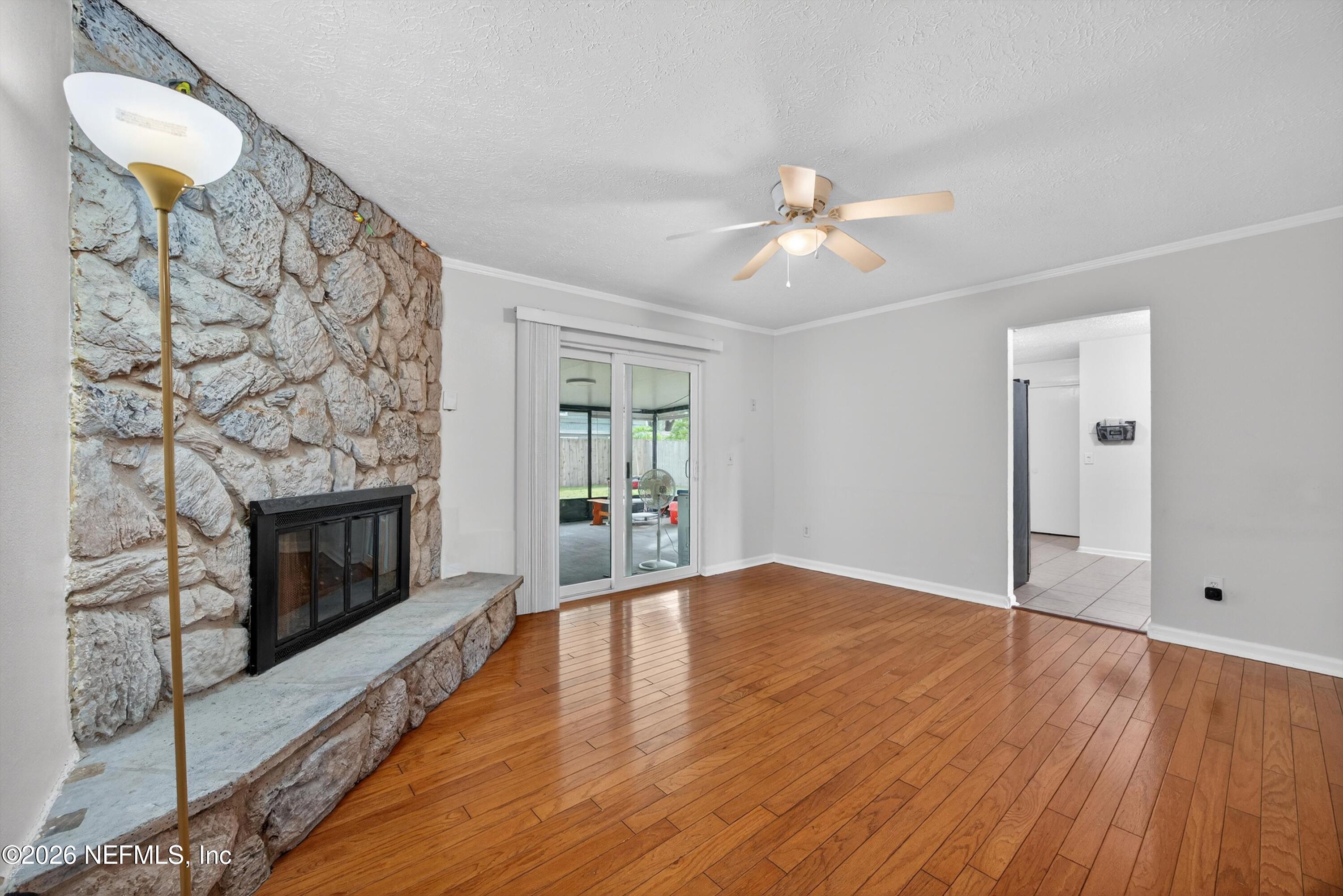 3570 Grassy Ride Drive Jacksonville, FL 32223 - Photo 16 of 51 a view of empty room with wooden floor and fireplace