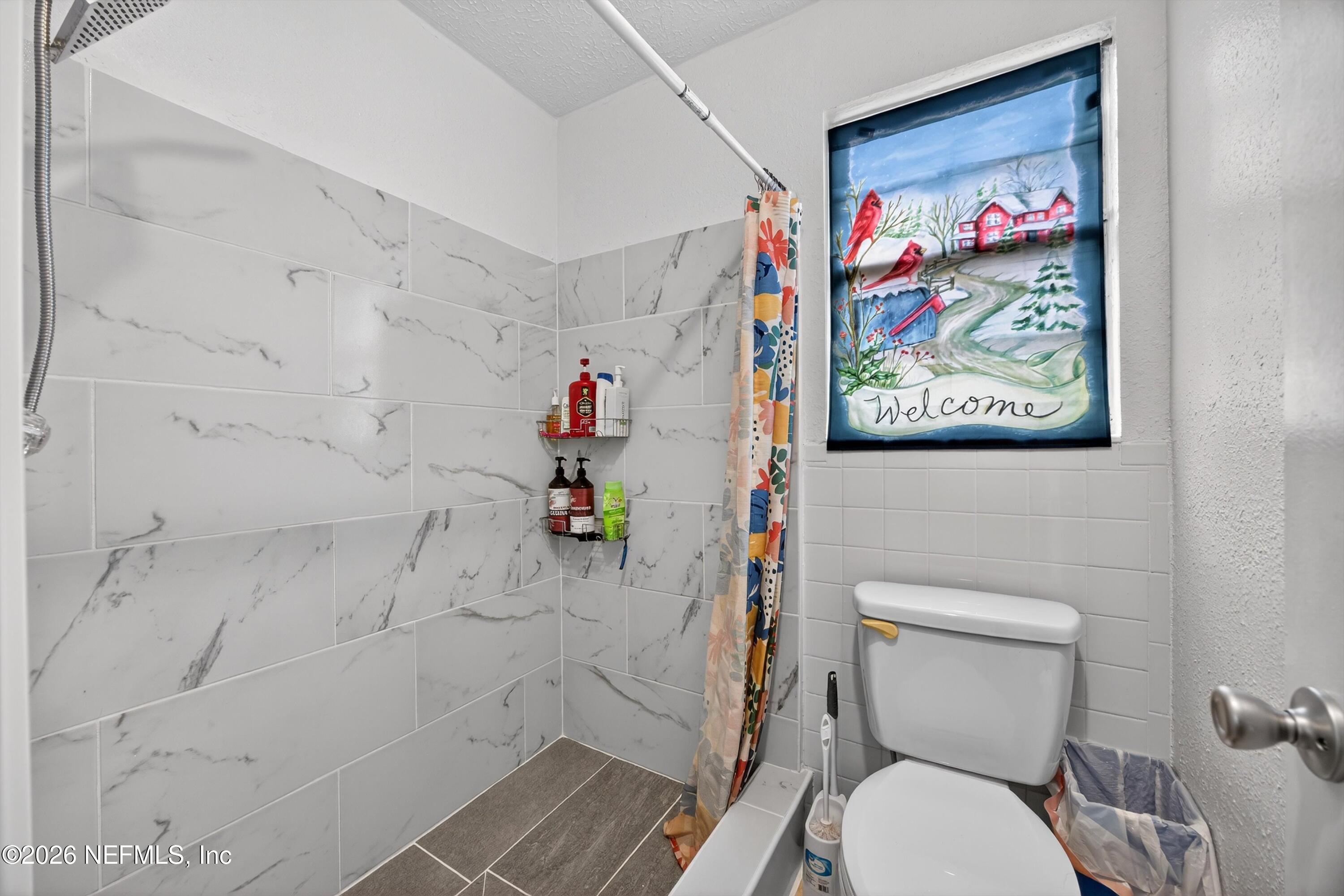 3570 Grassy Ride Drive Jacksonville, FL 32223 - Photo 25 of 51 a white toilet sitting next to a bathroom sink