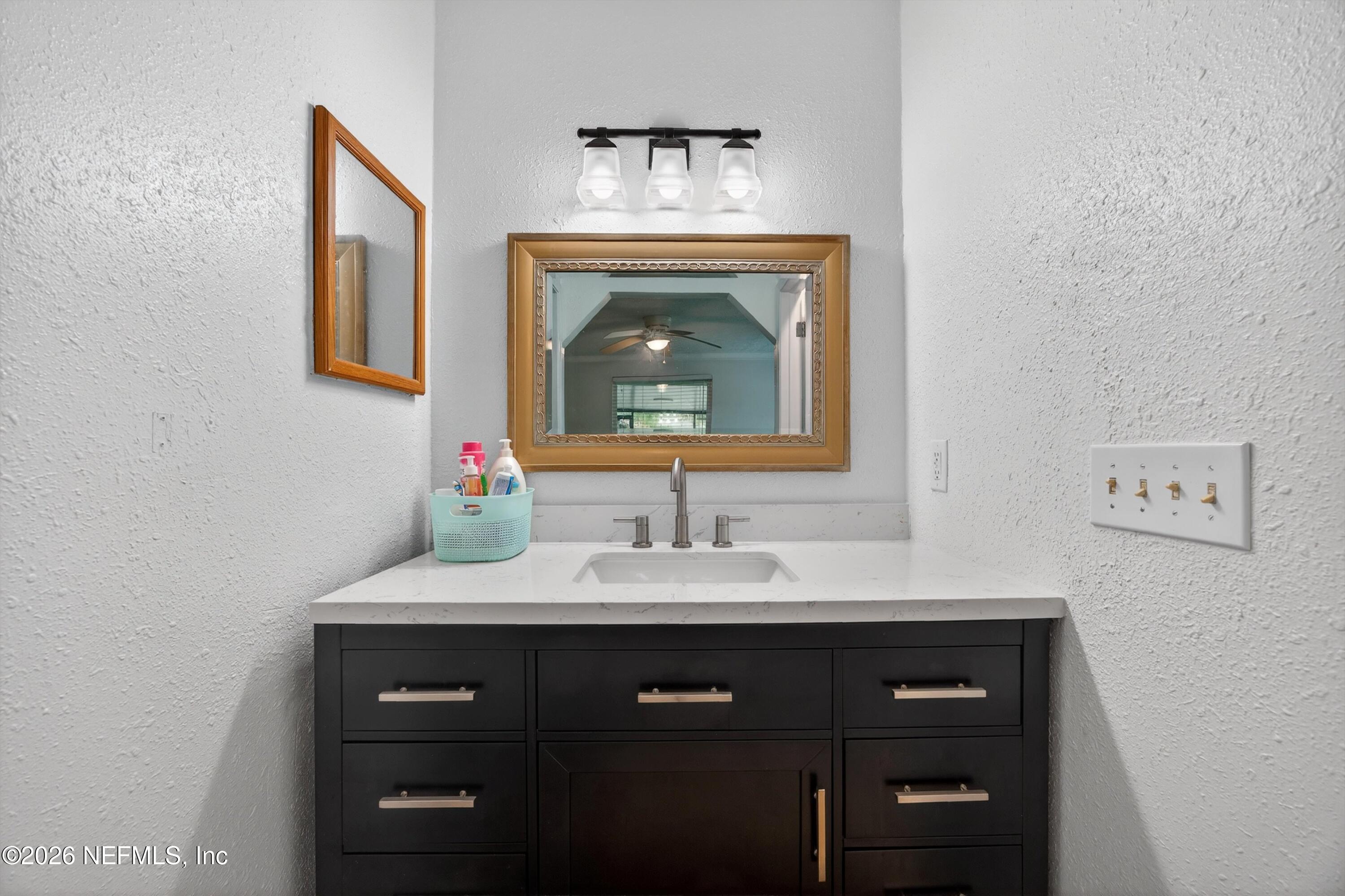 3570 Grassy Ride Drive Jacksonville, FL 32223 - Photo 26 of 51 a bathroom with a sink and a mirror
