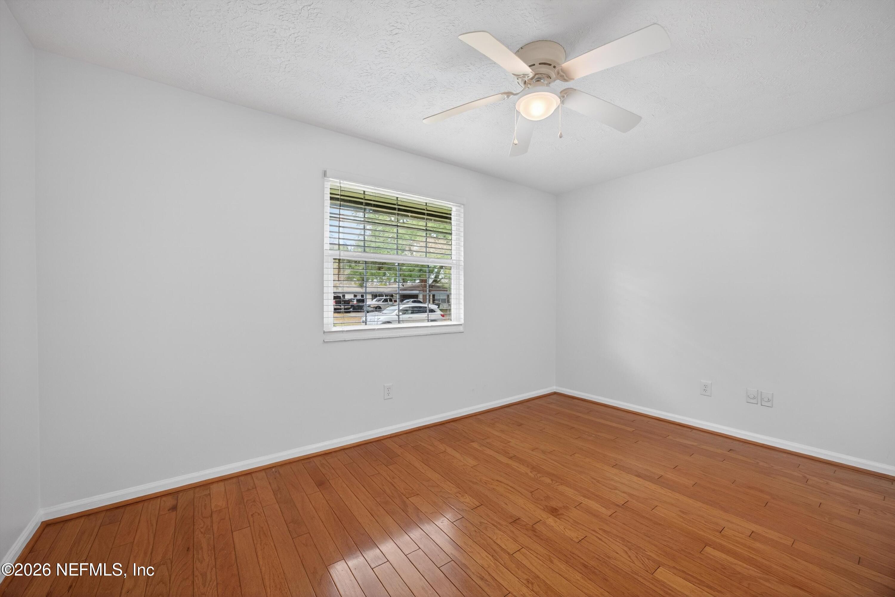 3570 Grassy Ride Drive Jacksonville, FL 32223 - Photo 27 of 51 an empty room with a window and a ceiling fan