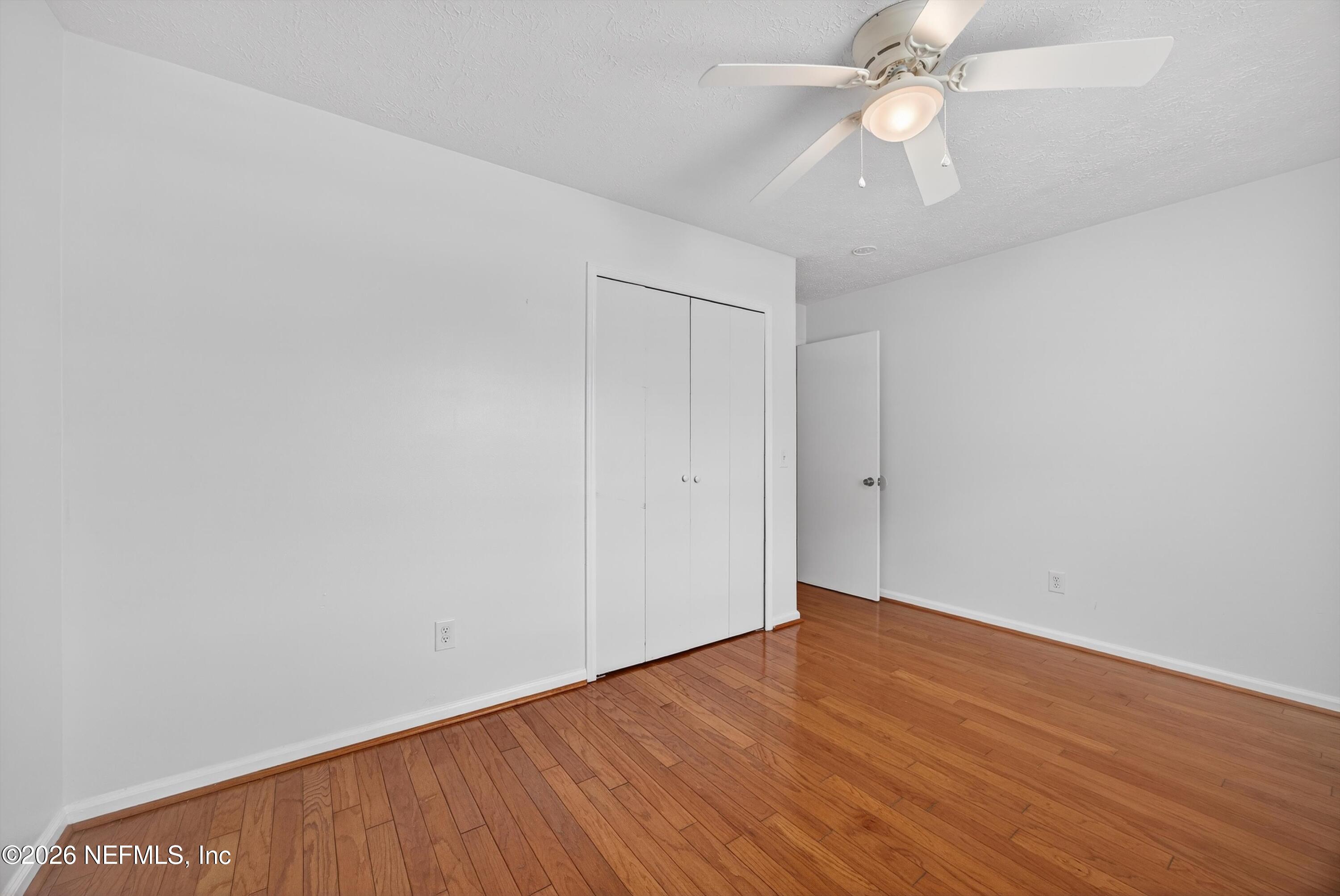 3570 Grassy Ride Drive Jacksonville, FL 32223 - Photo 28 of 51 a view of an empty room with wooden floor