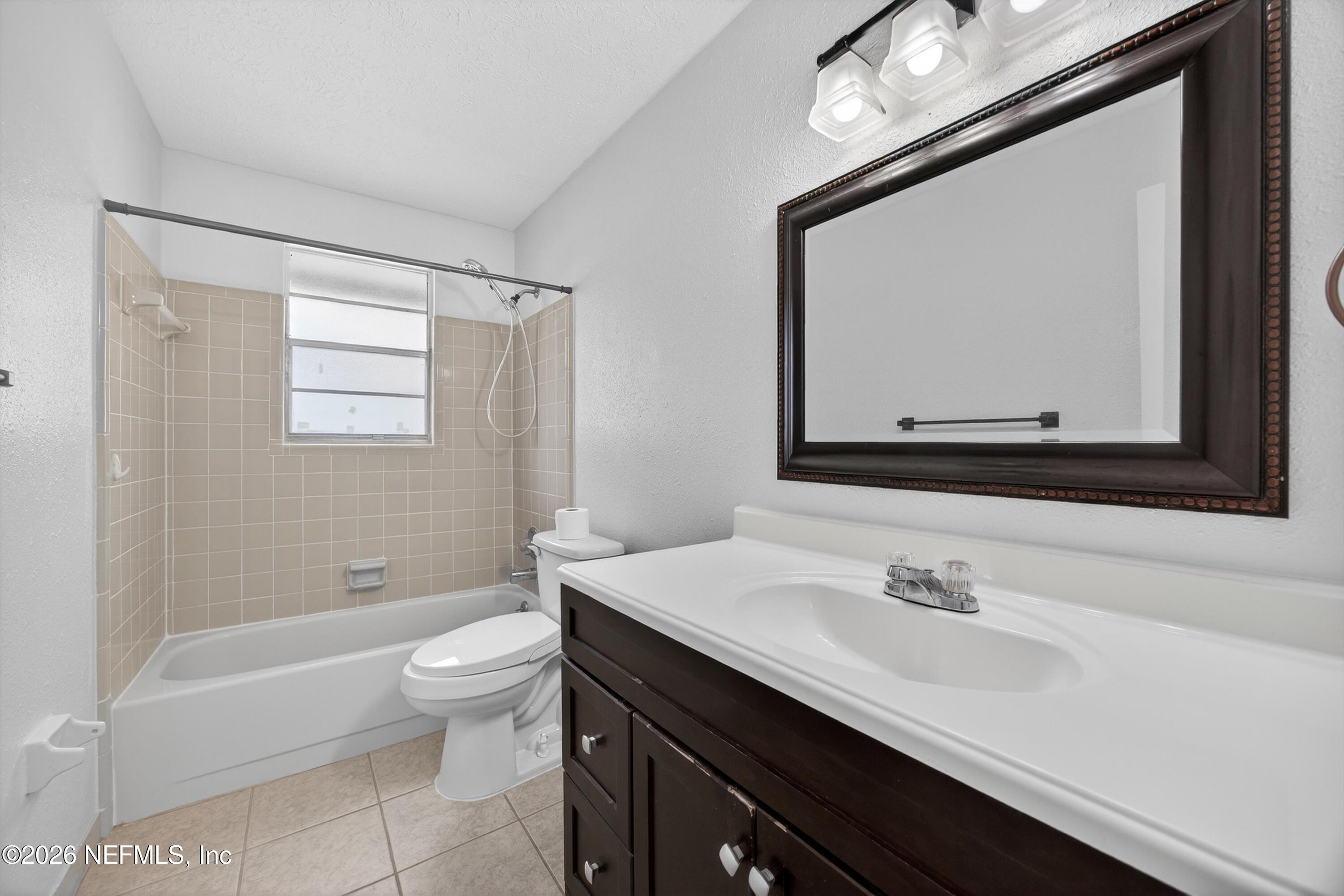 3570 Grassy Ride Drive Jacksonville, FL 32223 - Photo 29 of 51 a bathroom with a sink a toilet a mirror and bathtub