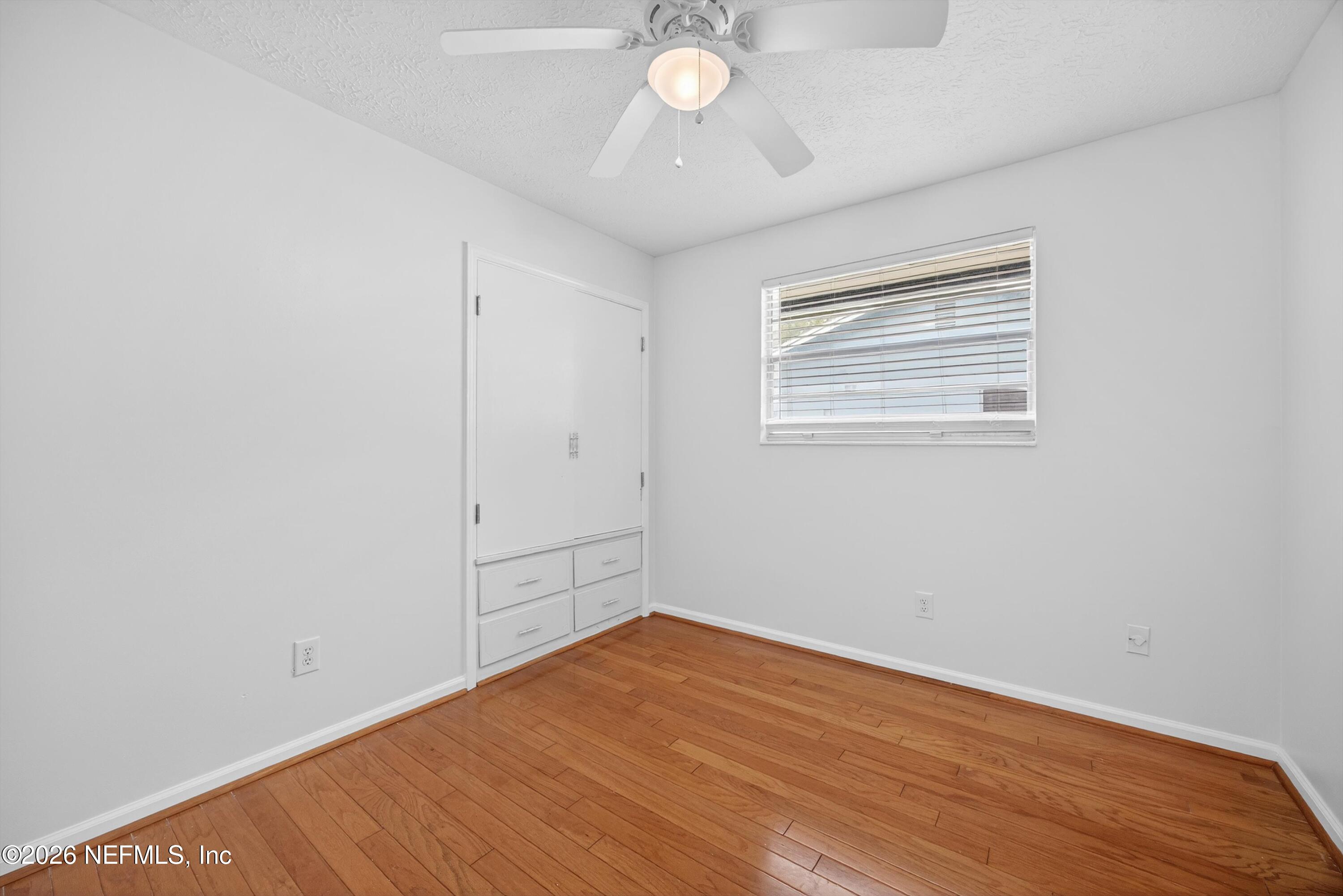 3570 Grassy Ride Drive Jacksonville, FL 32223 - Photo 30 of 51 an empty room with wooden floor and windows