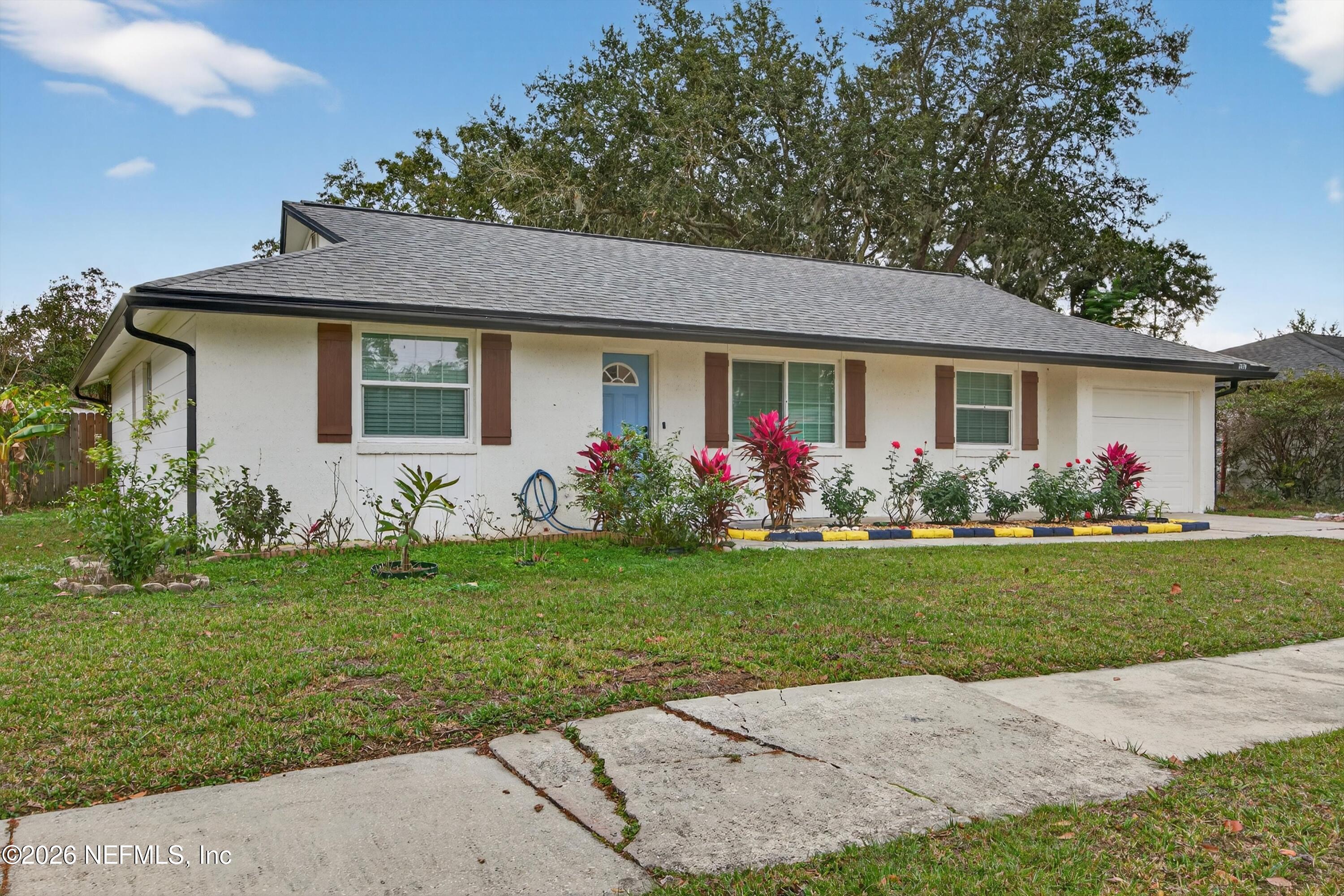 3570 Grassy Ride Drive Jacksonville, FL 32223 - Photo 4 of 51 a front view of house with yard and green space