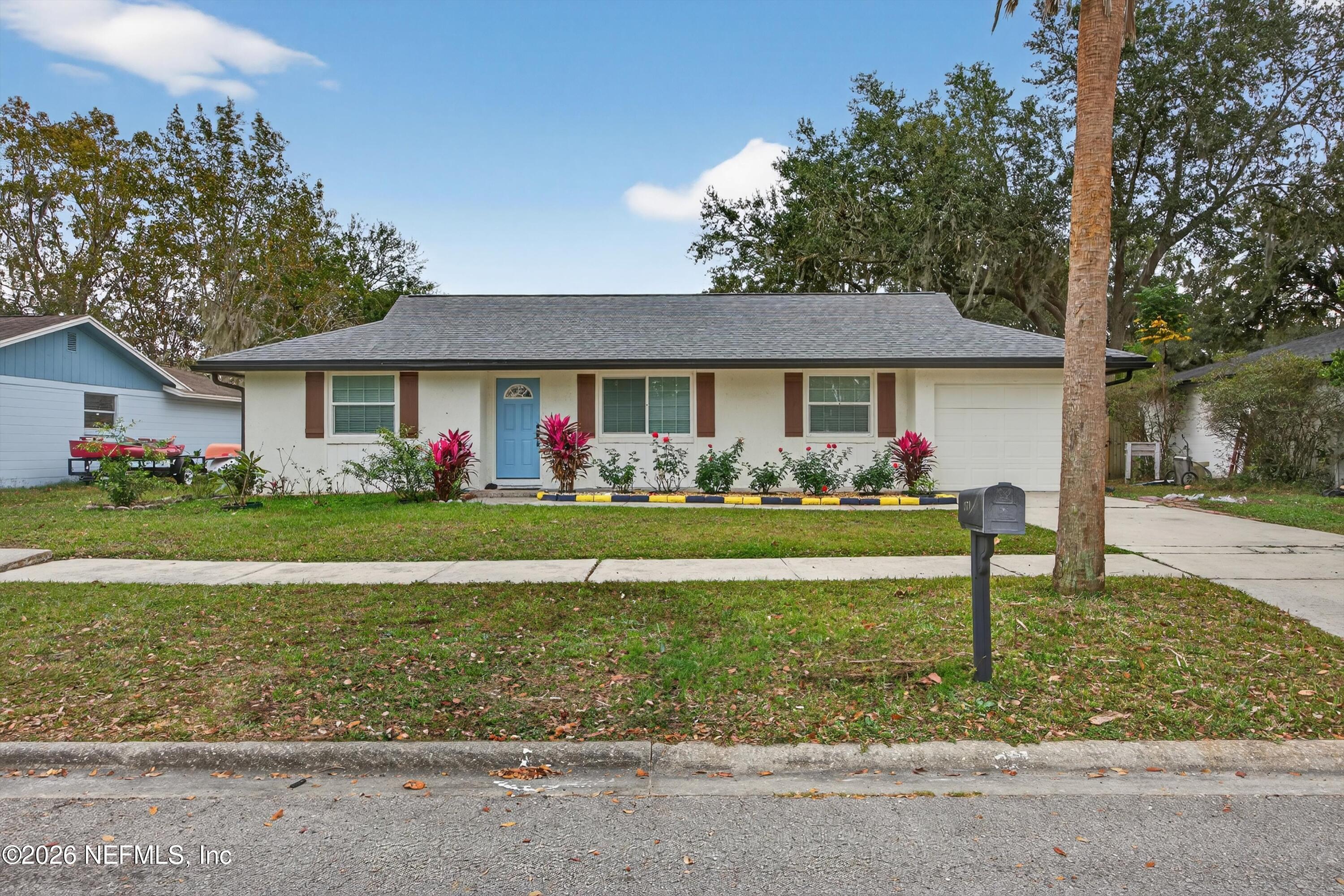 3570 Grassy Ride Drive Jacksonville, FL 32223 - Photo 6 of 51 a front view of house with garden and trees