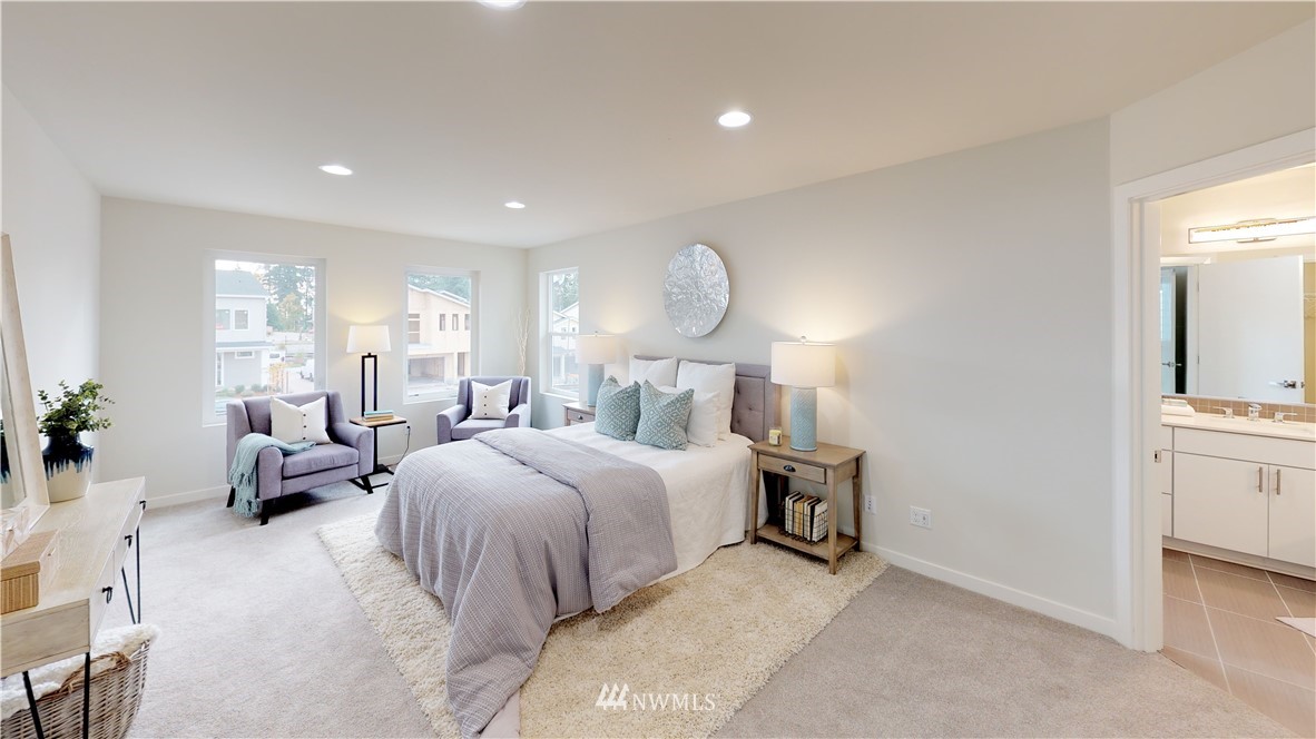 3129 193rd Place Southeast Bothell, WA 98012 - Photo 9 of 9 a spacious bedroom with a bed and a chandelier
