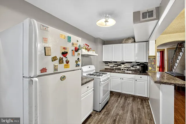 a white refrigerator freezer sitting inside of a kitchen