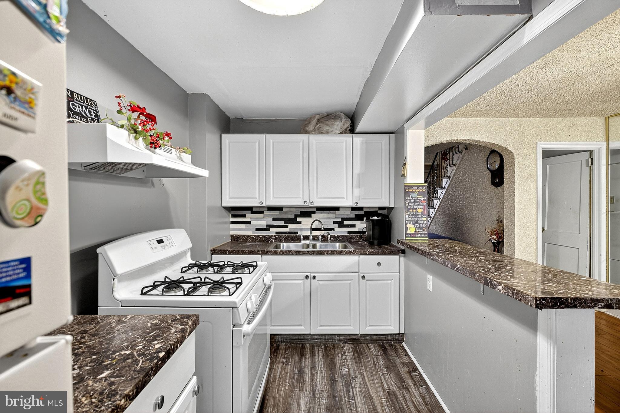252 North 9th Street Darby, PA 19023 - Photo 12 of 22 a kitchen with granite countertop a sink stove and refrigerator
