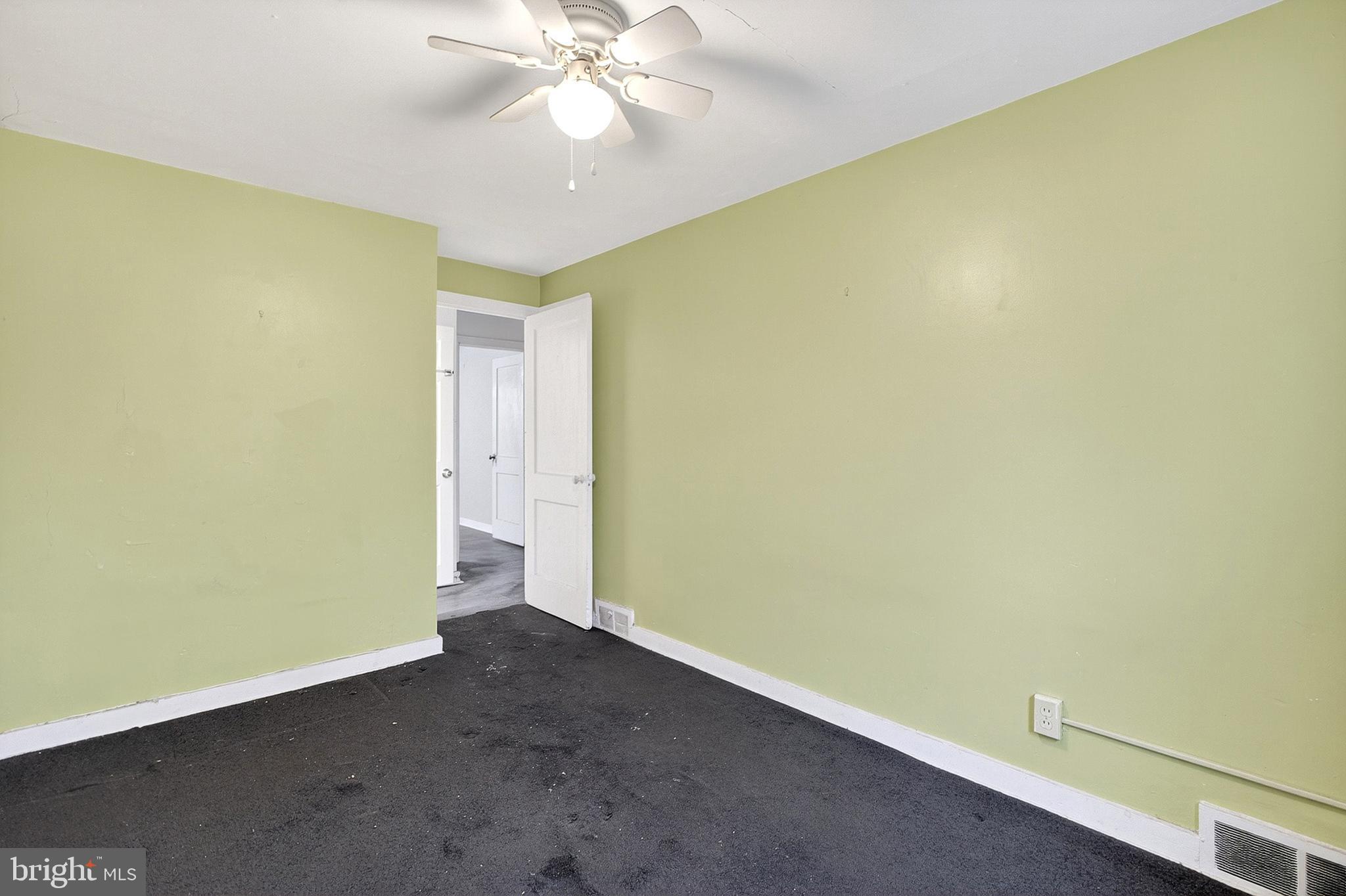252 North 9th Street Darby, PA 19023 - Photo 15 of 22 an empty room with a ceiling fan and carpet