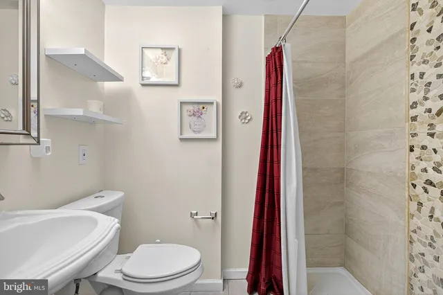 a white toilet sitting next to a bathroom sink