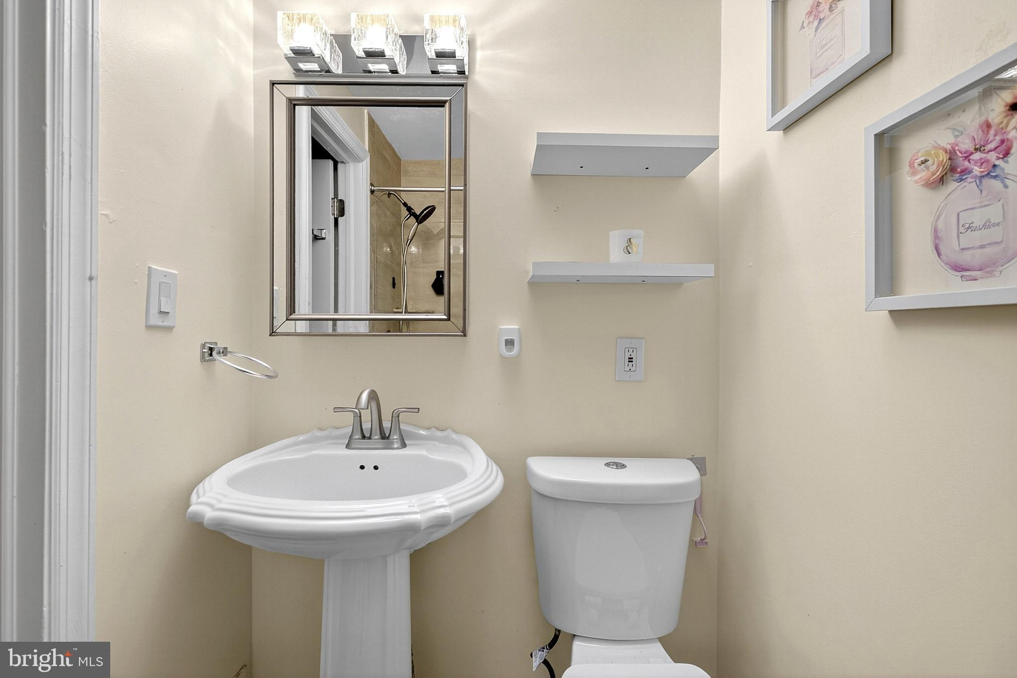 252 North 9th Street Darby, PA 19023 - Photo 18 of 22 a bathroom with a toilet sink and mirror