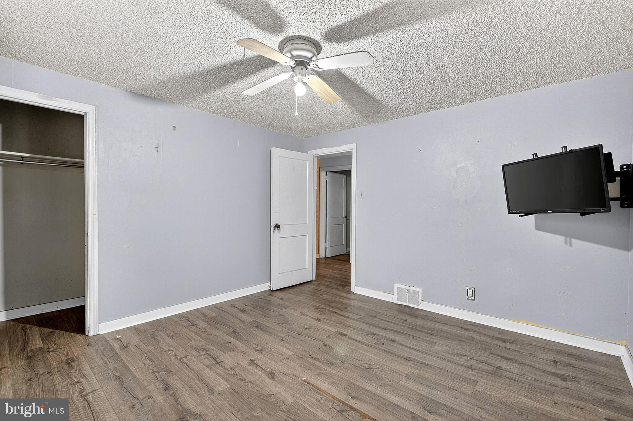 252 North 9th Street Darby, PA 19023 - Photo 20 of 22 a view of an empty room with wooden floor and a ceiling fan