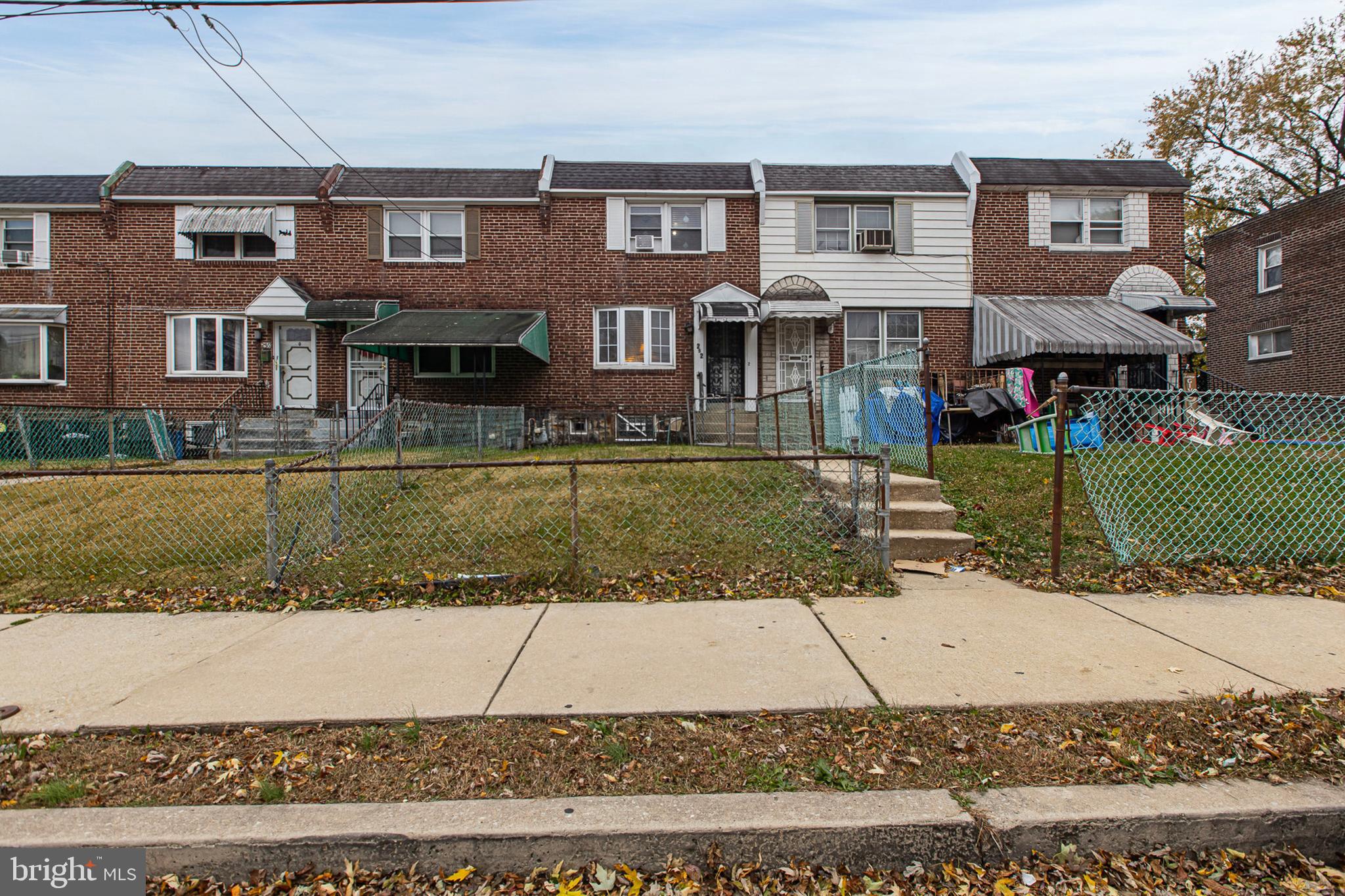 252 North 9th Street Darby, PA 19023 - Photo 2 of 22 front view of a brick house with a yard
