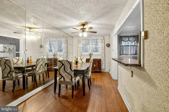 a very nice looking dining room with kitchen island a large window and stainless steel appliances