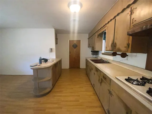 a kitchen with stainless steel appliances granite countertop a sink and a stove