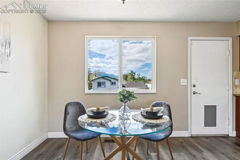 a view of a dining room with furniture and wooden floor