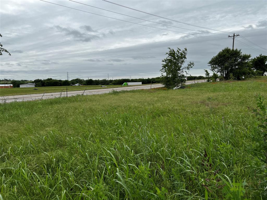 13501 Bates Aston Road Haslet, TX 76052 - Photo 4 of 4 a view of a field with a tree in front of it