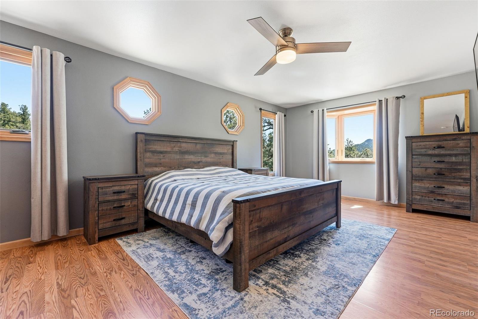 16687 Ouray Road West Pine, CO 80470 - Photo 20 of 49 a bed sitting in a spacious bedroom next to a window and a dresser