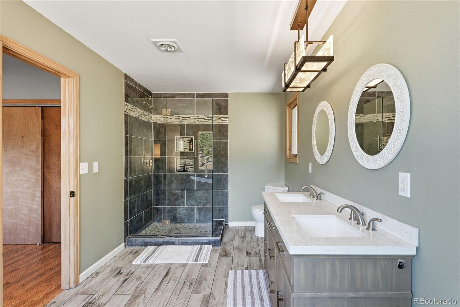 16687 Ouray Road West Pine, CO 80470 - Photo 23 of 49 a bathroom with a sink a mirror and shower