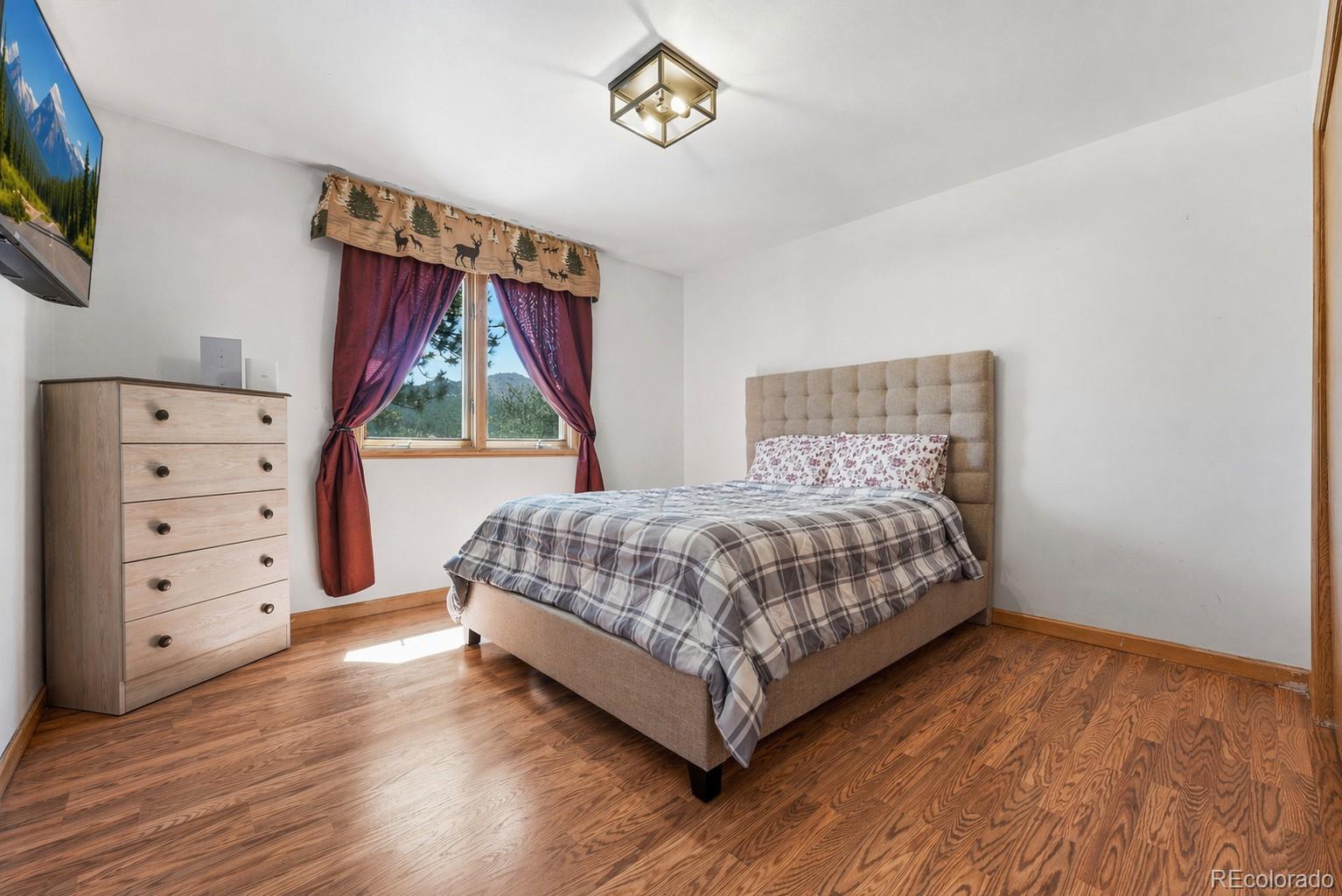 16687 Ouray Road West Pine, CO 80470 - Photo 29 of 49 a bedroom with a bed and a window