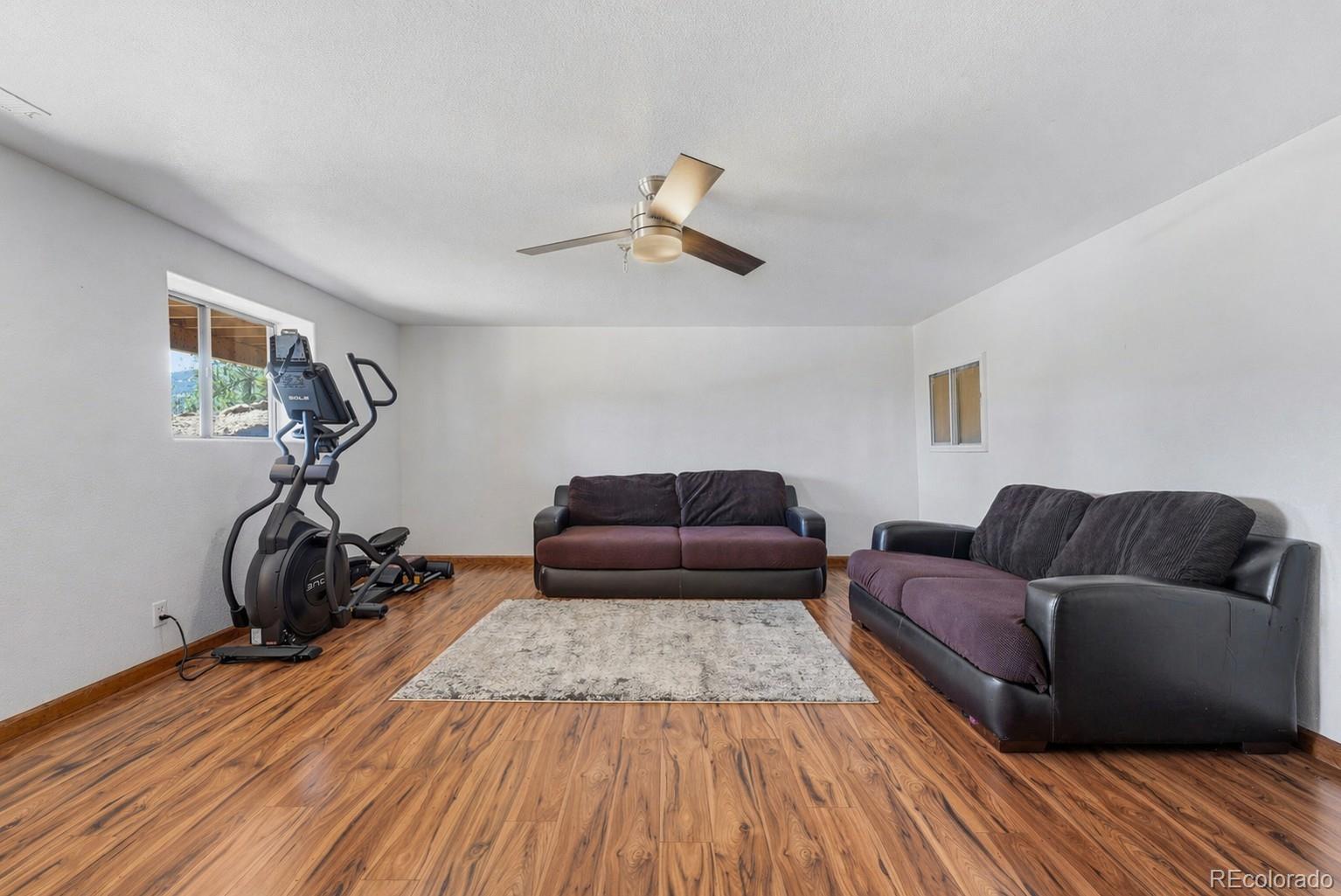 16687 Ouray Road West Pine, CO 80470 - Photo 30 of 49 a living room with furniture and a wooden floor