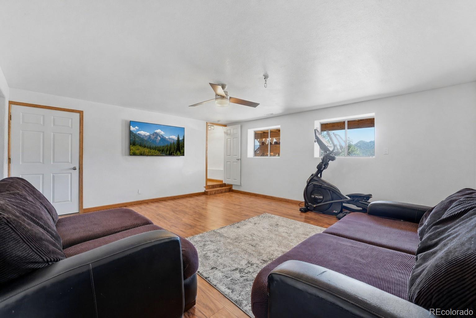16687 Ouray Road West Pine, CO 80470 - Photo 31 of 49 a living room with furniture and a flat screen tv