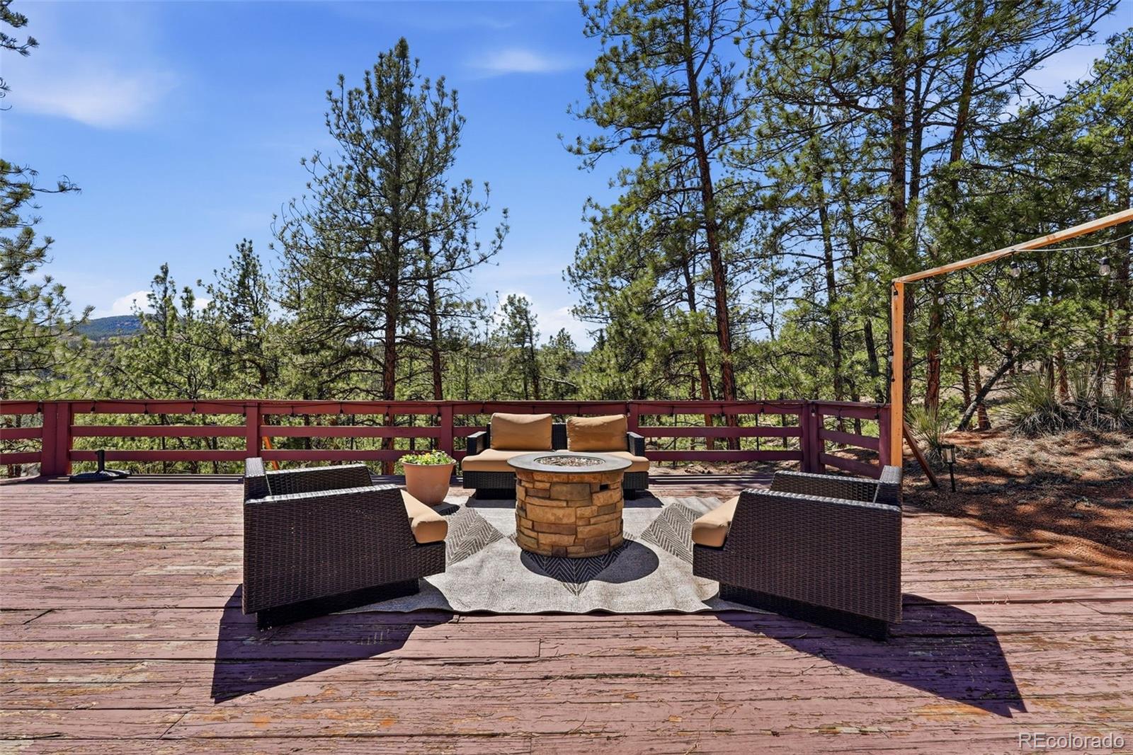 16687 Ouray Road West Pine, CO 80470 - Photo 35 of 49 a view of a terrace with furniture and trees